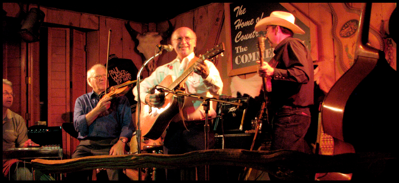 photo shows Lynn onstage sharing a smile with the backup band, including Paul Weber